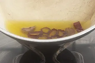 Padella con dentro il soffritto di aglio olio e peperoncino